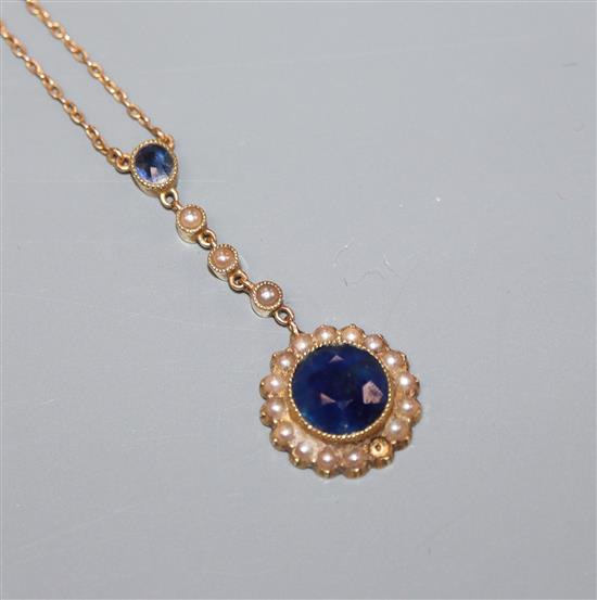 An early 20th century yellow metal ,sapphire and seed pearl set drop flowerhead pendant necklace, pendant 36mm.